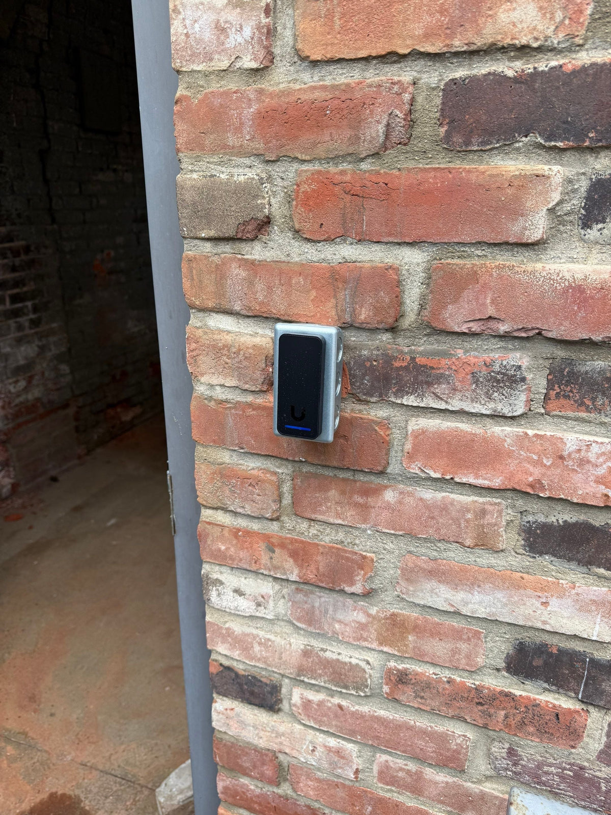 Access control reader on a brick wall
