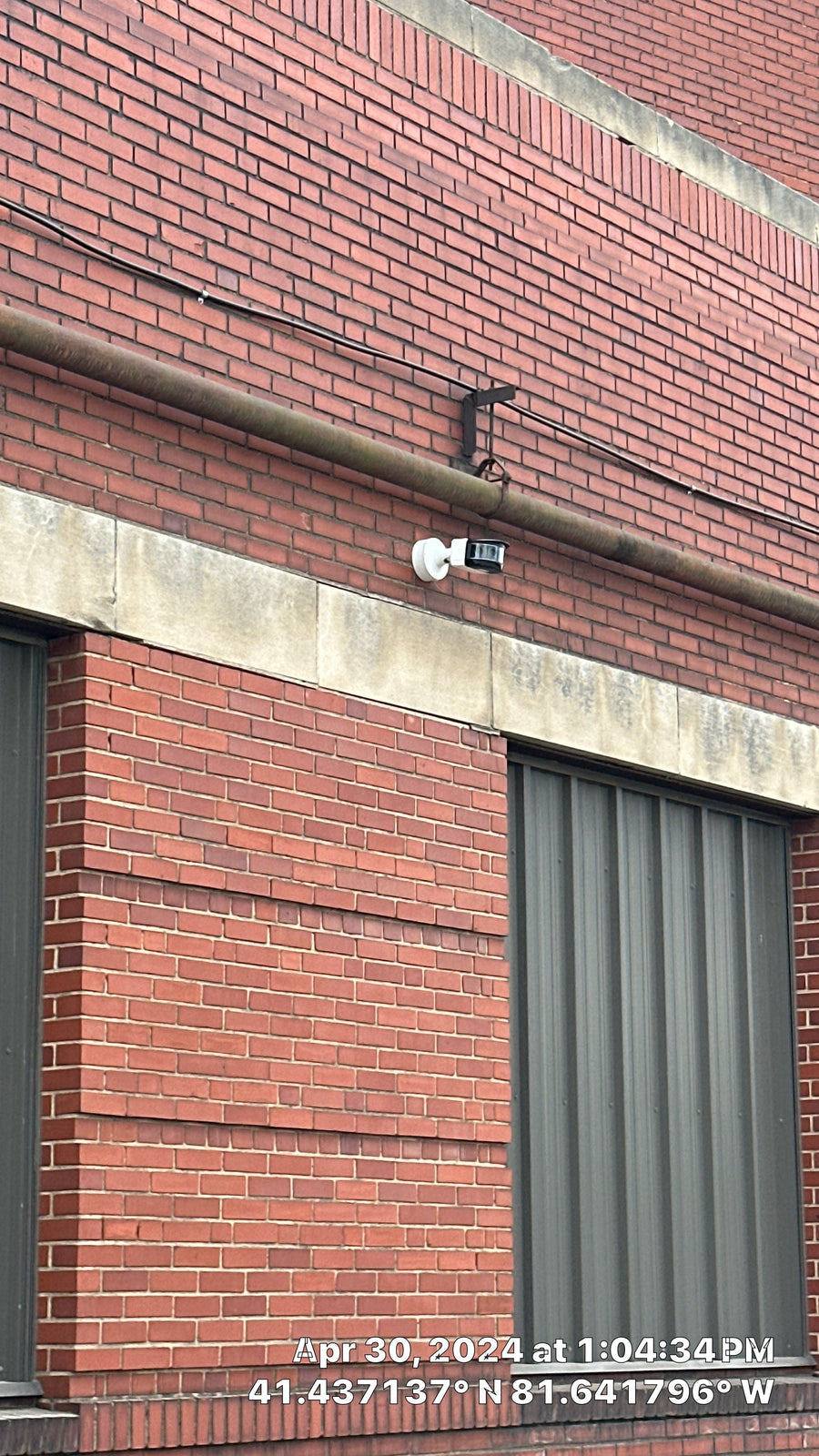 Exterior security camera above a loading door