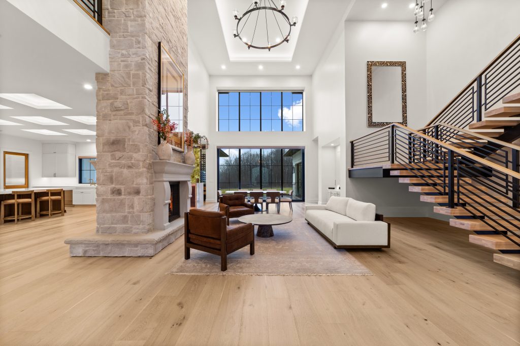 Open living room with large windows and recessed lighting