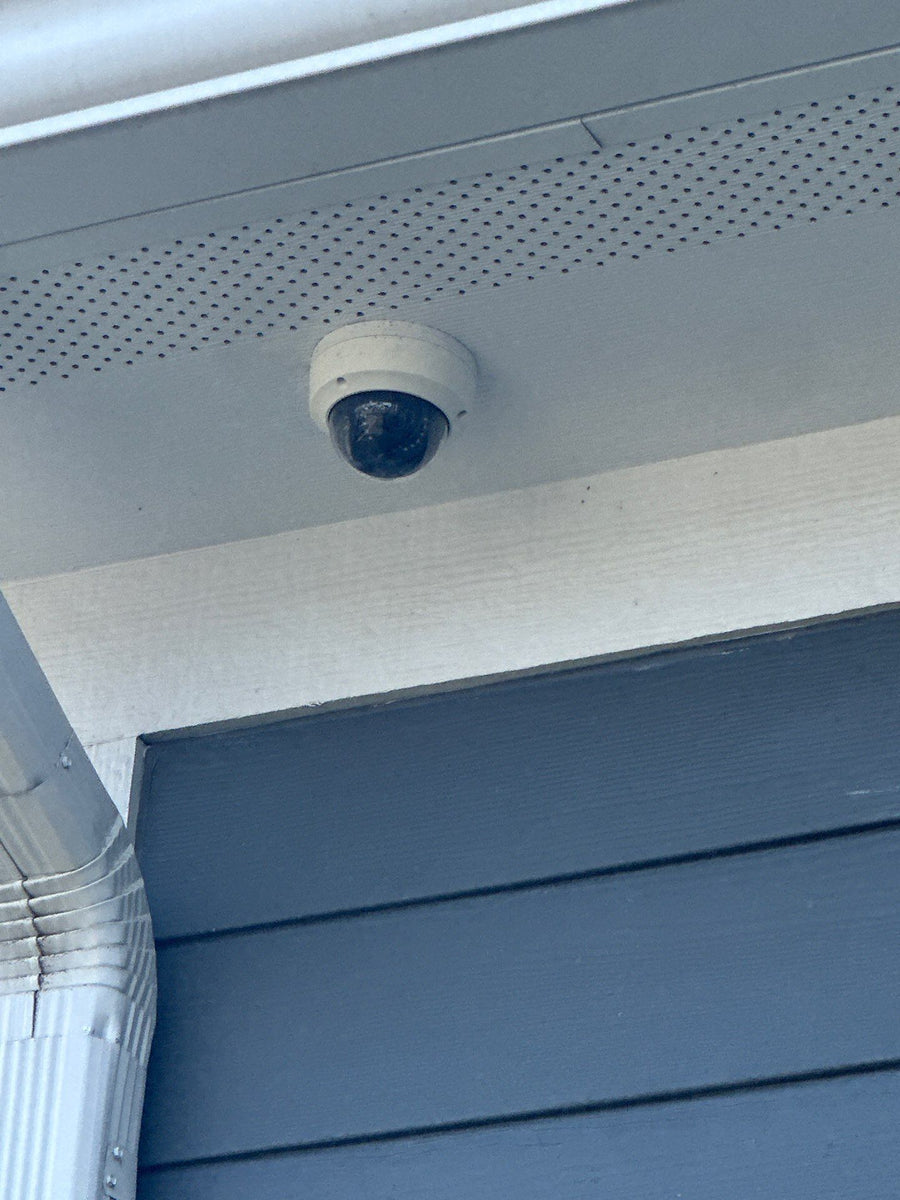 Dome security camera under an eave