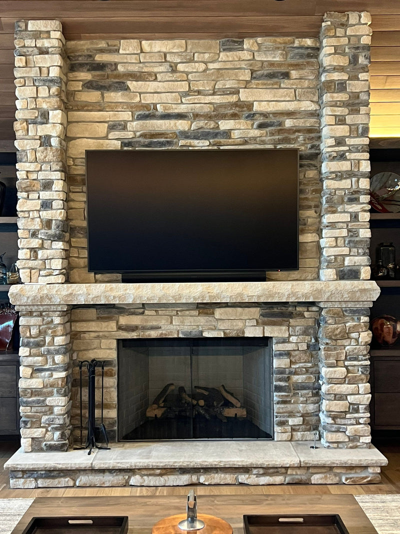 Large TV over a stone fireplace