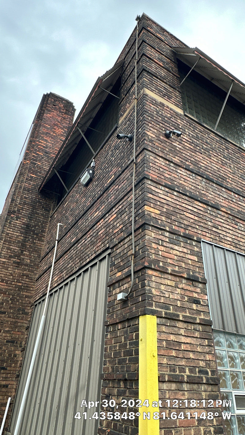 Cameras on the corner of a brick building