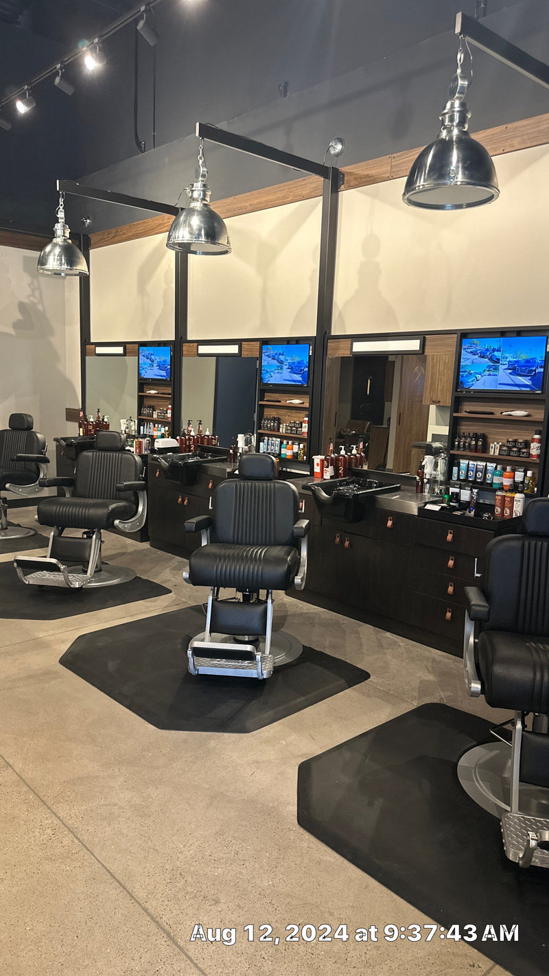 Grooming chair facing a row of station TVs