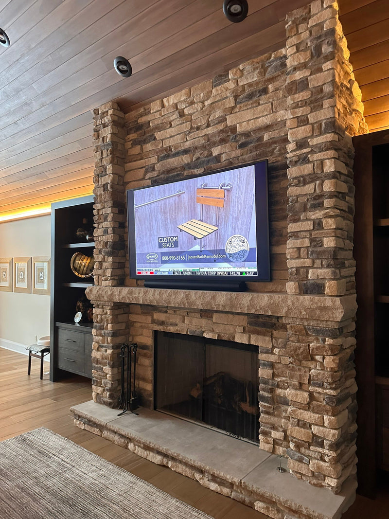 TV mounted on a brick fireplace wall