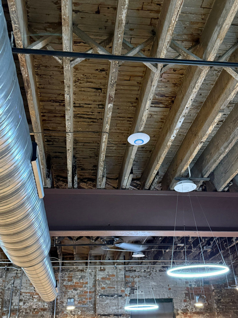 Cabling and camera run along an industrial ceiling