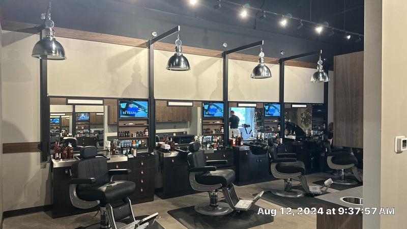 Grooming stations with TVs above each mirror