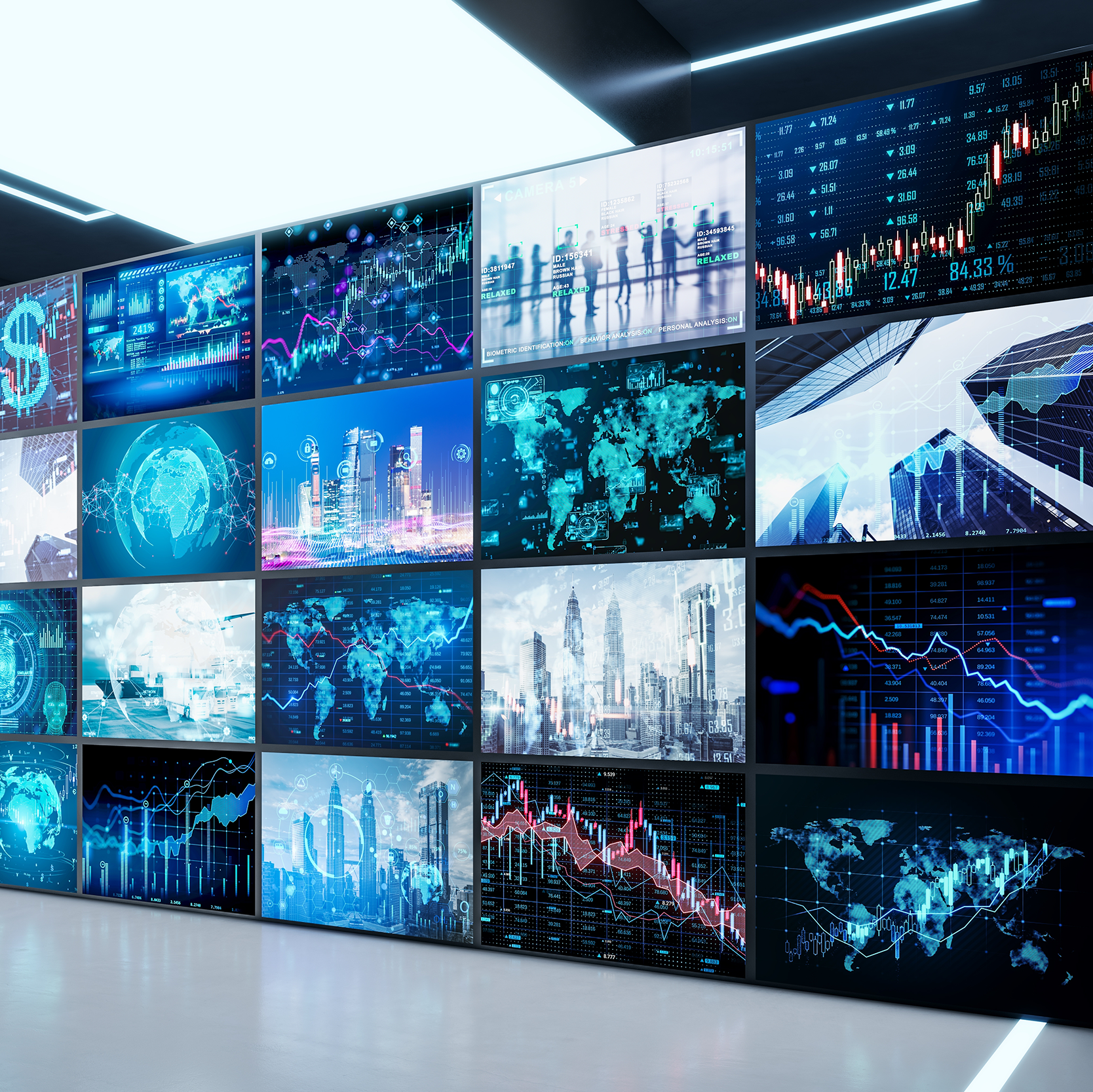 Person standing in front of a large wall of digital monitors displaying various data visualizations.